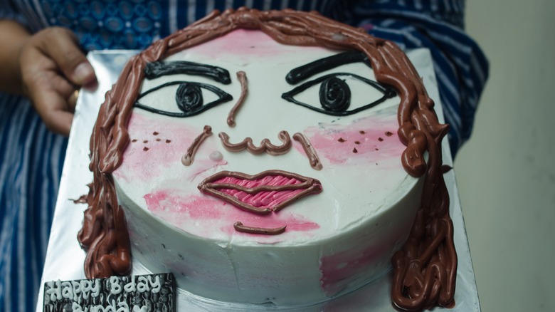 person holding an ugly cake