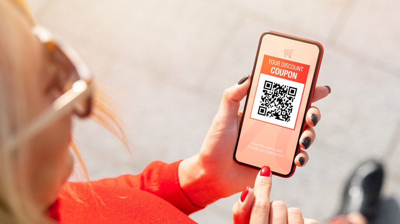 woman checking coupon on smartphone