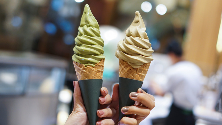 Hands holding soft serve cones