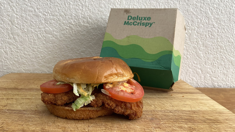 Spicy Deluxe McCrispy on cutting board with box