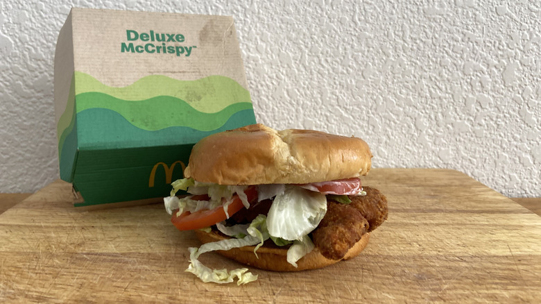 Deluxe McCrispy on cutting board with box