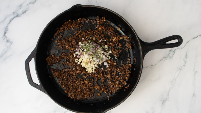 Sauteed mushrooms and aromatics in skillet