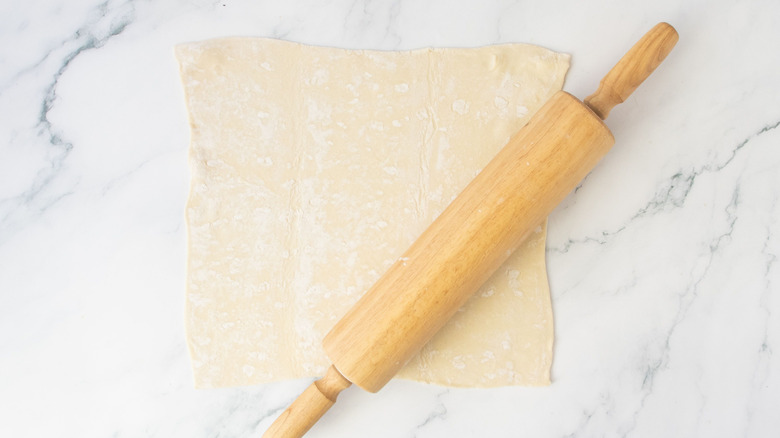 Puff pastry sheet with rolling pin