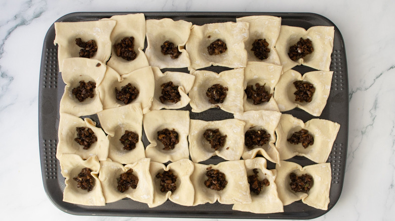 Pastry sheets and mushroom mixture in muffin tin
