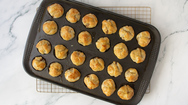 Pastry bites in muffin tin on wire rack