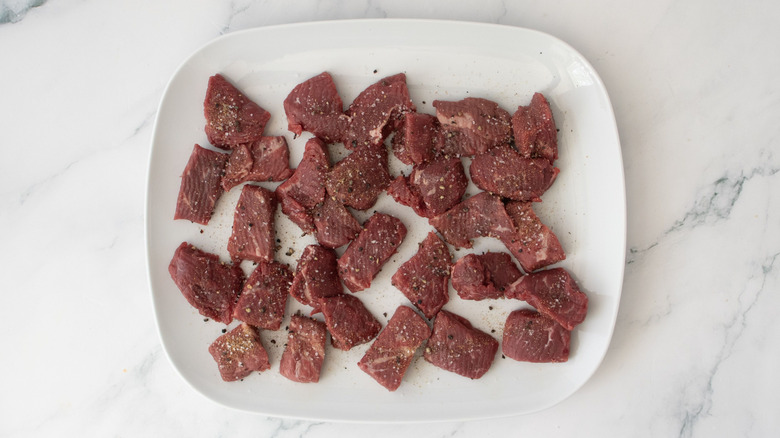 Seasoned steak pieces on plate