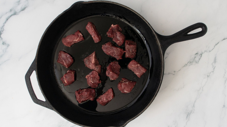 Steak pieces in skillet