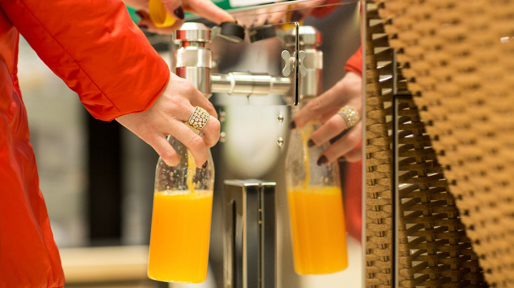 Orange juice poured from a machine