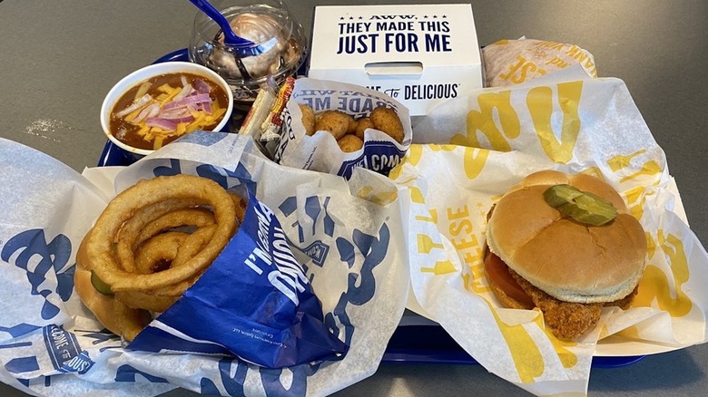 Culver's menu items in wrappers and containers including soup, onion rings, and a chicken sandwich
