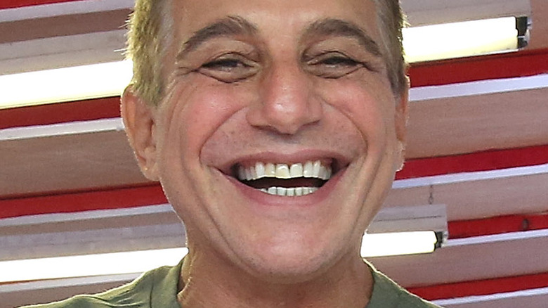 Tony Danza with wide smile serving up food 