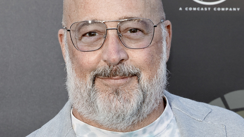 Andrew Zimmern with glasses and slight smile