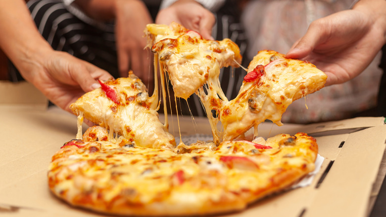 People splitting a pizza