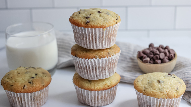 stack of chocolate chip muffins with glass of milk