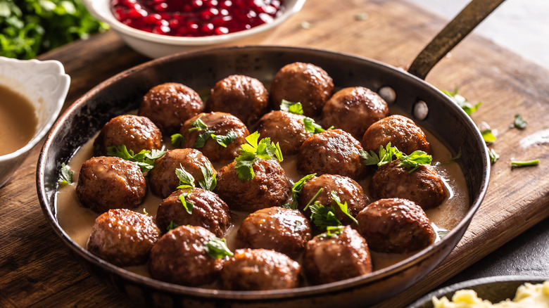 Garnished Swedish meatballs in a pan