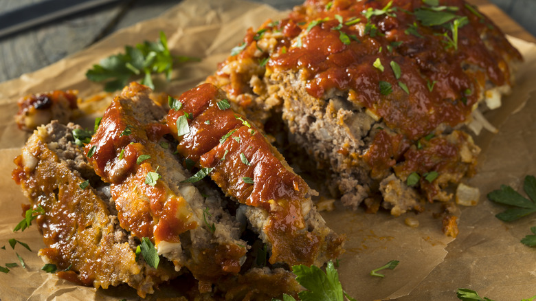 Slices of moist meatloaf garnished with parsley