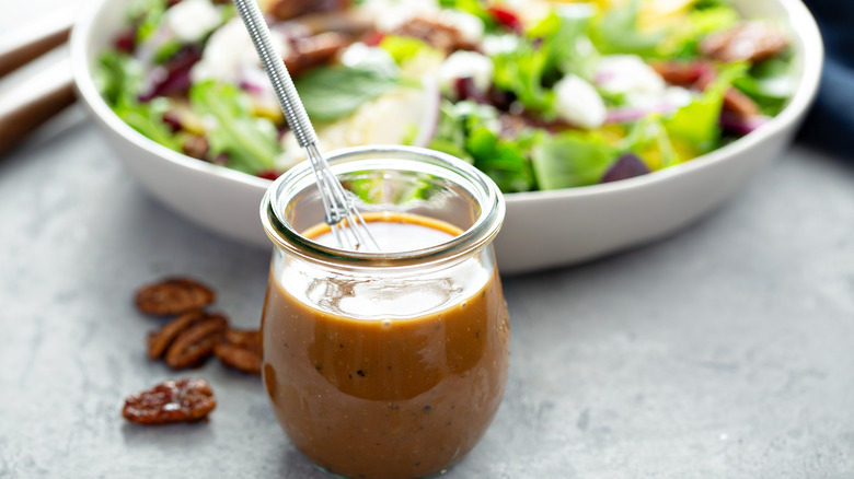 jar of vinaigrette with salad