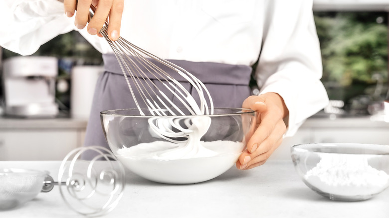 Young woman making whipped cream. Delicious food concept. Great design for any purposes.