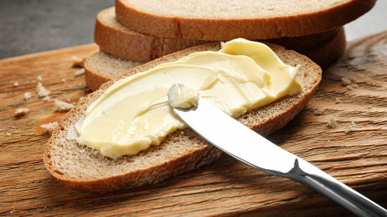 Spreading butter on bread with a knife