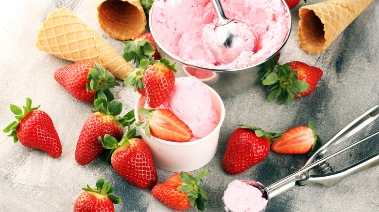 Strawberry ice cream with strawberries and empty cones