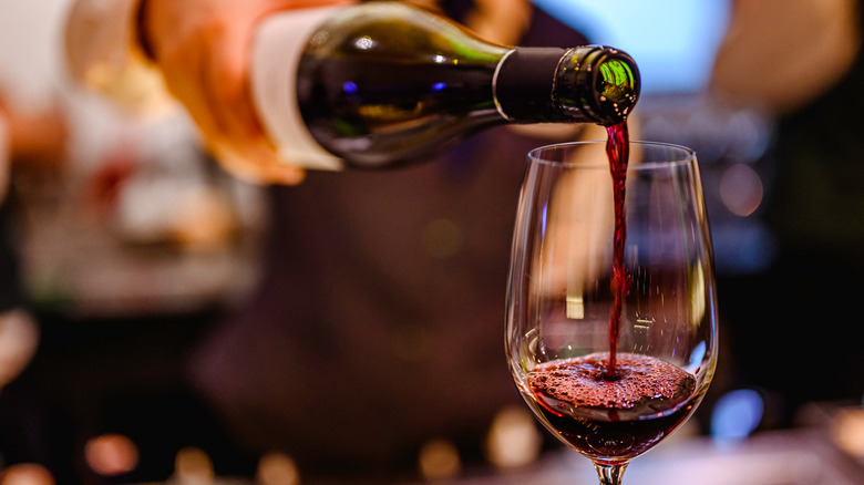 Red wine being poured into a glass