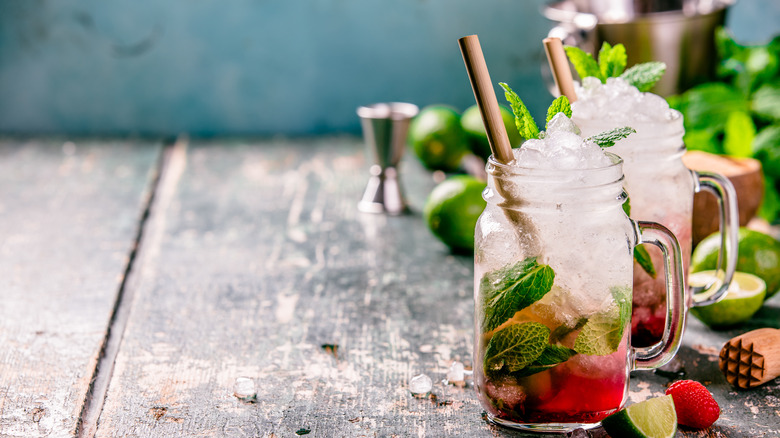 Glasses containing water, ice, mint and berries