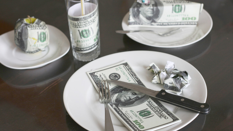 money on dinner plates