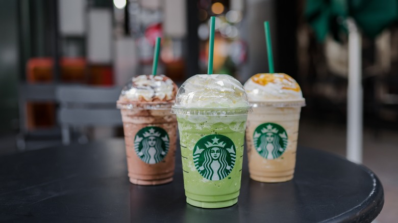 three Starbucks cold drinks on table