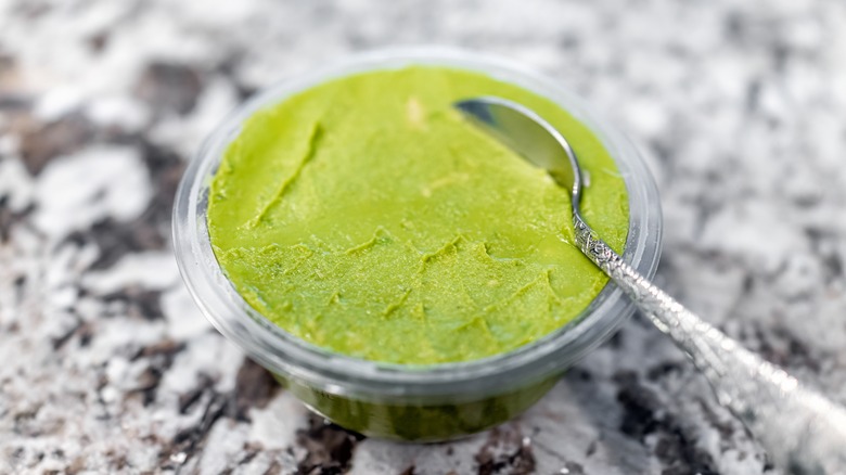 plastic guacamole container with spoon