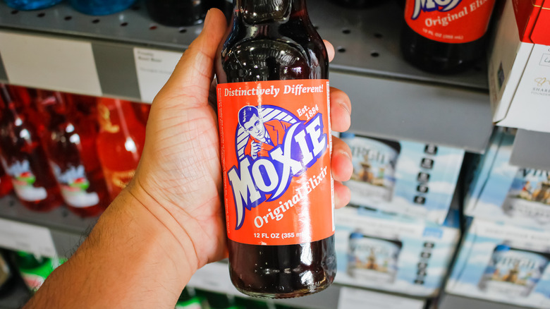 Man holds Moxie bottle