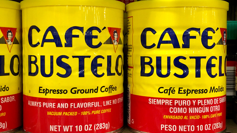 Row of yellow and red Café Bustelo canisters