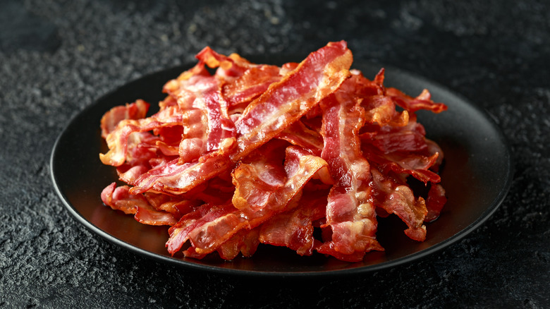 Strips of cooked bacon on a plate