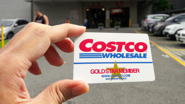 Woman holding Costco membership card