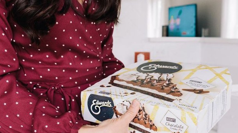 Woman holding Edwards frozen pie 