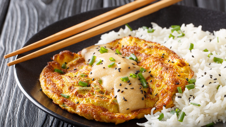 egg foo young on a plate with chopsticks