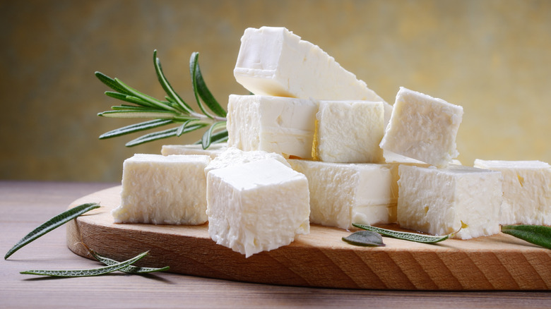feta cheese on board with rosemary