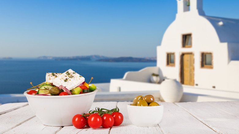 greek salad with greek island background