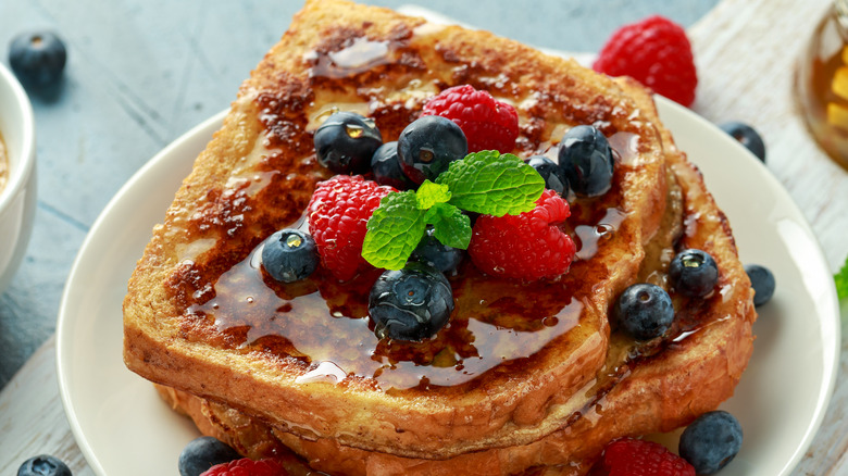 Stack of french toast covered in berries