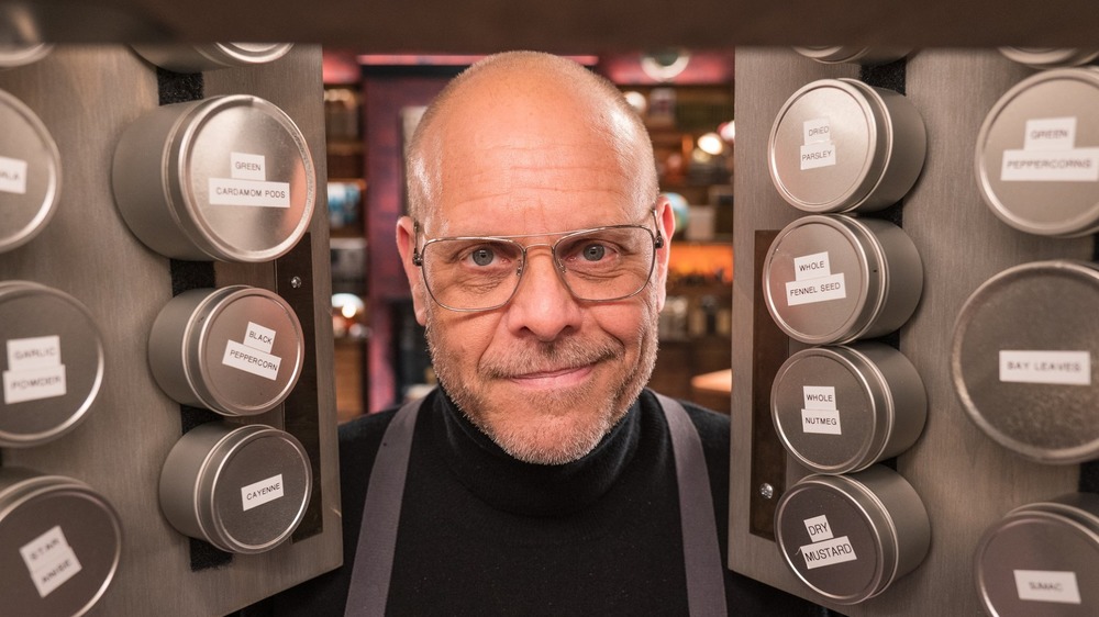 Alton Brown looking through spice cabinet