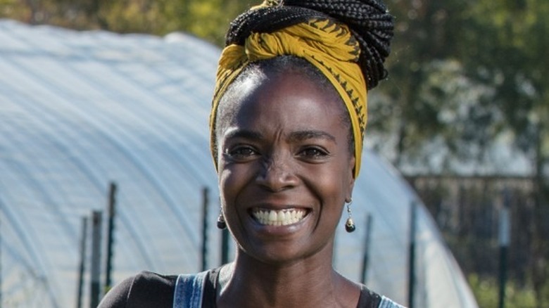 Jamila Norman smiling in denim overalls