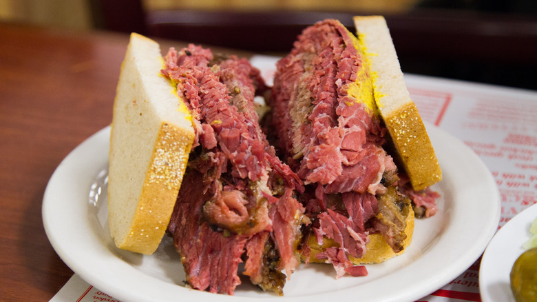 A freshly made smoked meat sandwich cut in half