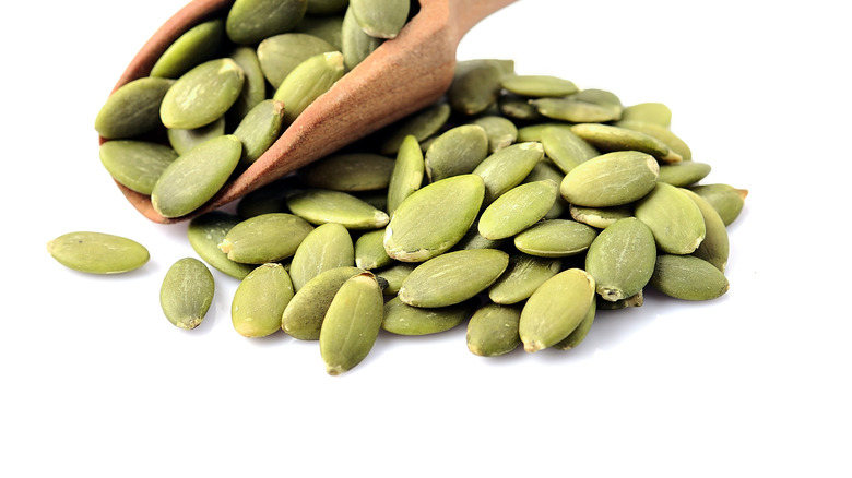 wooden spoon with pepita seeds