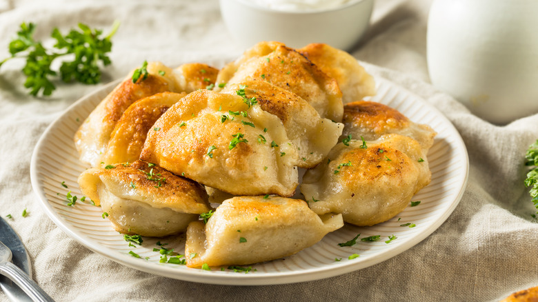 Pile of pierogies on white plate