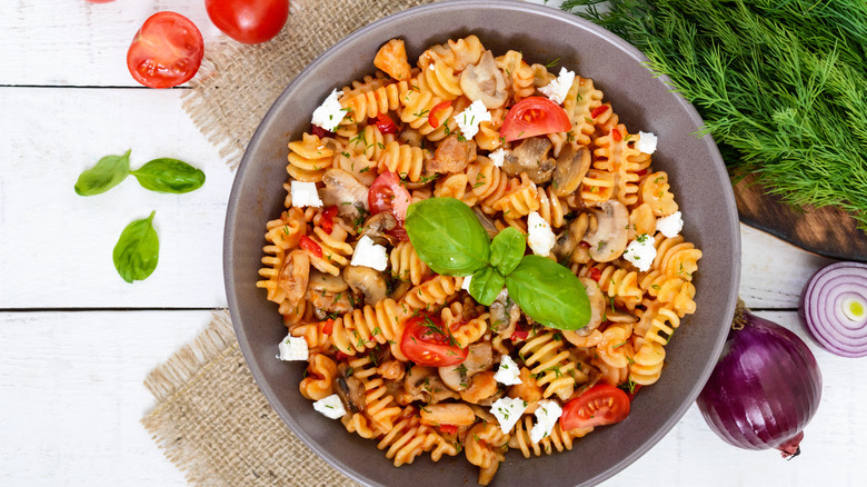 radiatori pasta dish with tomatoes, herbs, mushrooms, and cheese