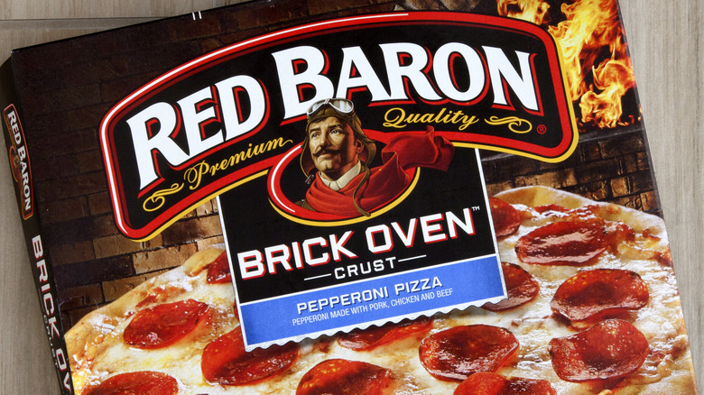 Red Baron pepperoni pizza box at an angle on a wooden background