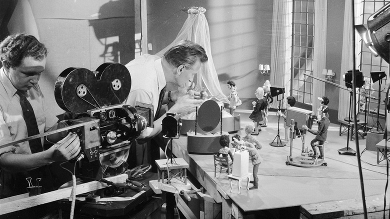 1950s cameraperson filming a sound stage.