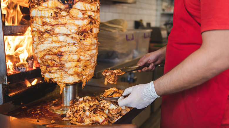Shawarma being prepared over a grill top 