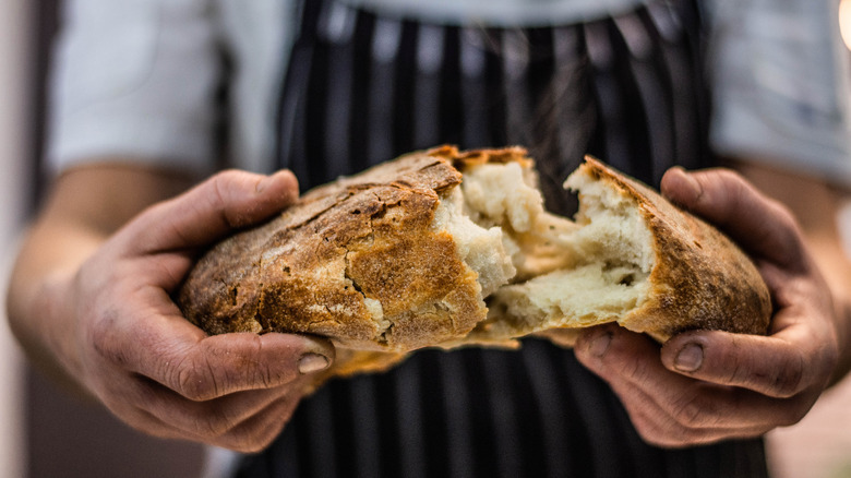 baker sourdough break loaf