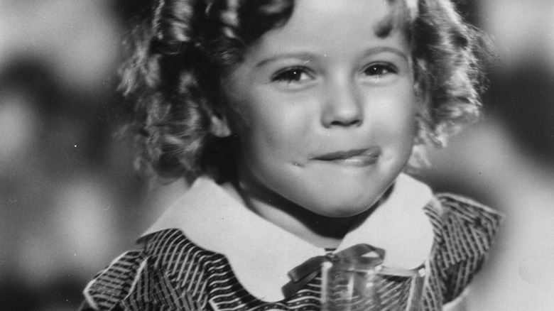 young shirley temple having a drink