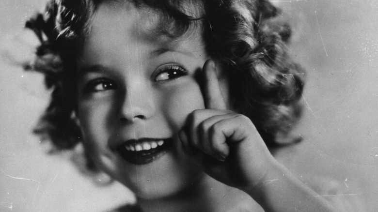 young shirley temple pointing up