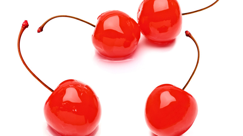 two shiny maraschino cherries